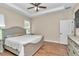 Main bedroom with tray ceiling, wood-look flooring, and natural light at 2525 Sw 7Th Ave, Ocala, FL 34471