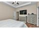 This main bedroom features wood-look flooring, a ceiling fan, and a television at 2525 Sw 7Th Ave, Ocala, FL 34471