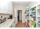 Well-stocked pantry with open shelving and granite countertops at 2525 Sw 7Th Ave, Ocala, FL 34471