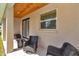 Covered porch featuring decorative columns, wood ceiling, and outdoor seating at 2525 Sw 7Th Ave, Ocala, FL 34471