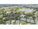Aerial view of the golf course, lake, pool and clubhouse amidst a charming neighborhood in a desirable location at 2608 Casso Ct, The Villages, FL 32162