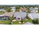 Charming home with manicured lawn, mature trees, and a cozy red-awning covered patio in a desirable neighborhood at 2608 Casso Ct, The Villages, FL 32162