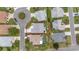 Aerial view shows property lines of a lovely home in a well-maintained neighborhood with mature landscaping at 2608 Casso Ct, The Villages, FL 32162