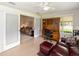 Versatile bonus room with tiled floors, home office setup, and a comfortable seating area at 2608 Casso Ct, The Villages, FL 32162
