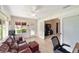 Bright bonus room with sliding doors, comfortable seating, and seamless indoor-outdoor living at 2608 Casso Ct, The Villages, FL 32162