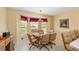 Bright dining area with many windows at 2608 Casso Ct, The Villages, FL 32162