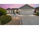 Charming single-story home featuring a bay window, lovely landscaping, and a two-car garage at 2608 Casso Ct, The Villages, FL 32162