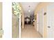 Bright foyer with tile flooring, arched doorway, and views into living spaces with neutral paint at 2608 Casso Ct, The Villages, FL 32162