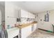 This garage features a sink, workspace, and cabinets, offering the homeowner space to complete projects at 2608 Casso Ct, The Villages, FL 32162