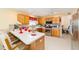 Kitchen with stainless appliances, tile backsplash and breakfast bar at 2608 Casso Ct, The Villages, FL 32162