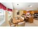 Open concept kitchen and dining area with stainless appliances and island at 2608 Casso Ct, The Villages, FL 32162