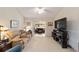 Comfortable living room with a plush tan sofa and a ceiling fan for added comfort at 2608 Casso Ct, The Villages, FL 32162