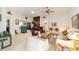 Large living room with bookcase and ceiling fan at 2608 Casso Ct, The Villages, FL 32162