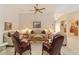 Neutral living room featuring a ceiling fan, ample seating, and lots of natural light at 2608 Casso Ct, The Villages, FL 32162