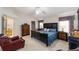 Spacious main bedroom with neutral walls, carpet, ceiling fan, and a comfortable bed at 2608 Casso Ct, The Villages, FL 32162