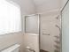 This bathroom features a shower with white tile and sliding glass doors, with safety bars installed for accessibility at 2608 Casso Ct, The Villages, FL 32162