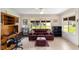 Bright sunroom with large windows, comfortable seating, and a workspace for added convenience at 2608 Casso Ct, The Villages, FL 32162