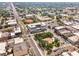 Aerial view showcasing a modern condo building in a lively downtown area with streets and businesses at 302 Se Broadway St # 240, Ocala, FL 34471