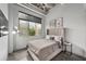 Bedroom with concrete floors, a comfortable bed, and a bright window with an outdoor view at 302 Se Broadway St # 240, Ocala, FL 34471