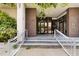 Building entrance featuring stairway, glass doors, and brick columns, offering a welcoming exterior at 302 Se Broadway St # 240, Ocala, FL 34471