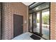 Building entrance with glass doors and brick accents, providing a modern and inviting facade at 302 Se Broadway St # 240, Ocala, FL 34471