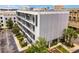 Modern condo building exterior featuring private balconies, lush landscaping, and a contemporary design at 302 Se Broadway St # 240, Ocala, FL 34471