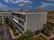 Modern condo building exterior featuring private balconies, lush landscaping, and a contemporary design at 302 Se Broadway St # 240, Ocala, FL 34471