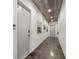Hallway features concrete floors, door 240, door 260, and 3 wall pictures on the side wall at 302 Se Broadway St # 240, Ocala, FL 34471