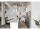 Hallway features office and open kitchen view with modern decor and lighting, connecting spaces seamlessly at 302 Se Broadway St # 240, Ocala, FL 34471