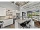 The kitchen features stainless steel appliances and an island, seamlessly flowing into the living area for modern living at 302 Se Broadway St # 240, Ocala, FL 34471