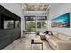 Comfortable living room with concrete floors, sectional sofa, balcony access, and a mounted television at 302 Se Broadway St # 240, Ocala, FL 34471