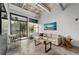 Comfortable living room with concrete floors, balcony access, and neighborhood views at 302 Se Broadway St # 240, Ocala, FL 34471