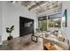 Bright living room featuring concrete floors, a comfortable sectional sofa, and large windows with natural light at 302 Se Broadway St # 240, Ocala, FL 34471
