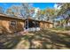 A sprawling backyard with a screened-in porch, blending indoor and outdoor living at 3299 County Road 521, Wildwood, FL 34785