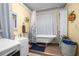 Charming bathroom features a clawfoot tub and vintage-inspired decor at 3299 County Road 521, Wildwood, FL 34785