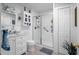 All white bathroom features a glass shower, and convenient built-in storage at 3299 County Road 521, Wildwood, FL 34785