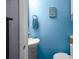 Bright blue paneled walls add to the charm of this cozy and functional bathroom at 3299 County Road 521, Wildwood, FL 34785