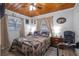 Bedroom boasts natural light, wood-look floors, and neutral-toned walls at 3299 County Road 521, Wildwood, FL 34785
