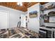 Bedroom with a television, adjacent to an office space, and wood-look floors at 3299 County Road 521, Wildwood, FL 34785