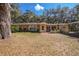 Charming front exterior with decorative touches, mature trees, and a well-maintained lawn at 3299 County Road 521, Wildwood, FL 34785