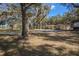 Exterior shot of the front of the property, highlighting the spacious front yard at 3299 County Road 521, Wildwood, FL 34785