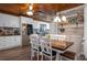 Eat-in kitchen featuring a dining table set next to the kitchen with white cabinets and stainless steel appliances at 3299 County Road 521, Wildwood, FL 34785