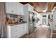 Beautiful white kitchen featuring modern appliances, wooden ceiling, and coffee bar setup at 3299 County Road 521, Wildwood, FL 34785