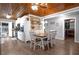 Eat-in kitchen features a dining table set next to the kitchen with white cabinets and modern appliances at 3299 County Road 521, Wildwood, FL 34785