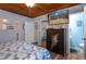 A television in this main bedroom, hangs near the doorway leading to the ensuite bathroom at 3299 County Road 521, Wildwood, FL 34785