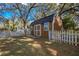 Exterior shot of fenced shed with double doors at 3299 County Road 521, Wildwood, FL 34785