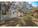 Backyard features a storage shed with a quaint white picket fence at 3299 County Road 521, Wildwood, FL 34785