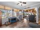 Bright sunroom flowing into the living room, offering views and versatile space with wood-look vinyl flooring at 3299 County Road 521, Wildwood, FL 34785