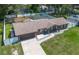 Aerial view of brick house with an attached garage, manicured lawn, and fenced backyard at 3881 Se 61St Pl, Ocala, FL 34480