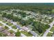 Wide aerial view of a quiet community with lush foliage and single Gathering homes at 3881 Se 61St Pl, Ocala, FL 34480